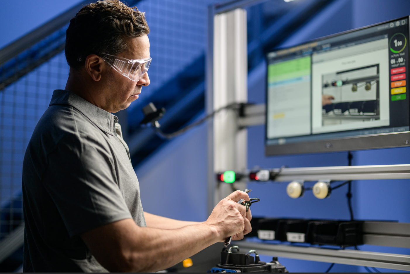 manufacturing operator completing a connected gauge task during assembly